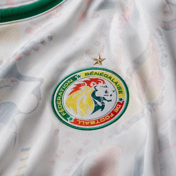 Senegal football crest on white jersey fabric background