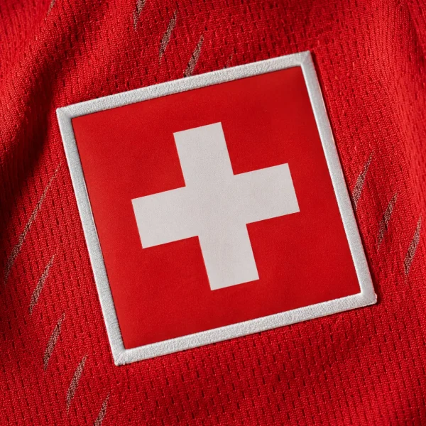 Switzerland football flag on red jersey fabric background