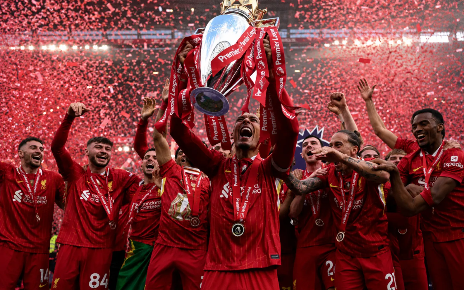 Liverpool football jersey celebration with players lifting a trophy