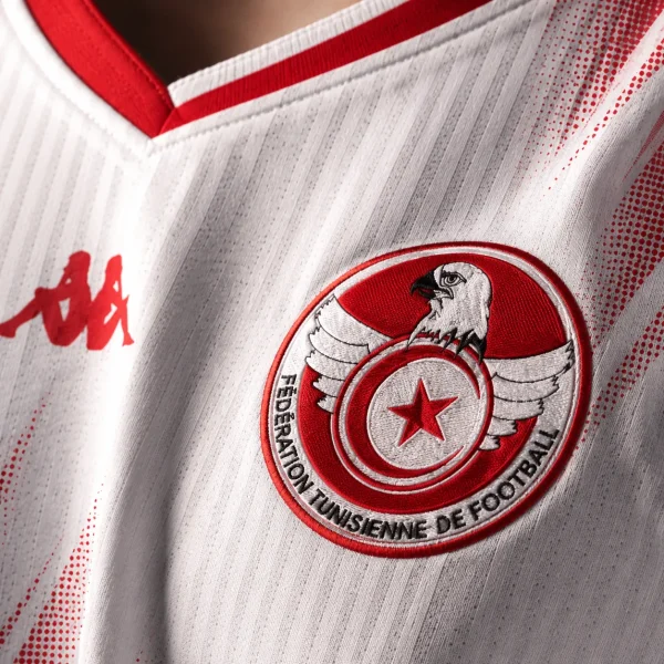 Tunisia football crest on white jersey fabric background